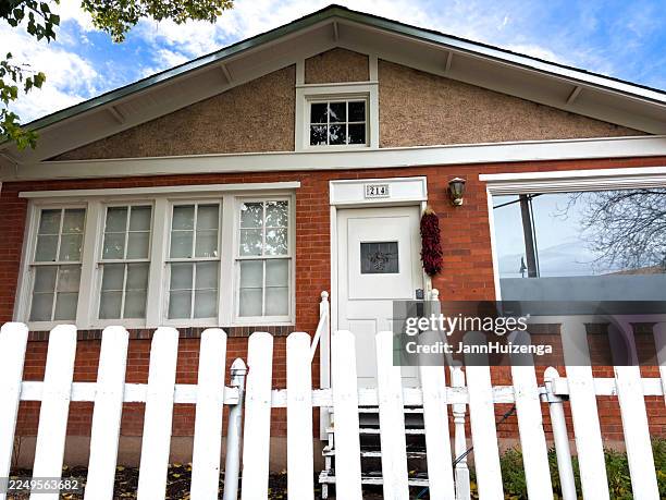 santa fe, nm: downtown red brick house with white picket fence - white picket gate stock pictures, royalty-free photos & images