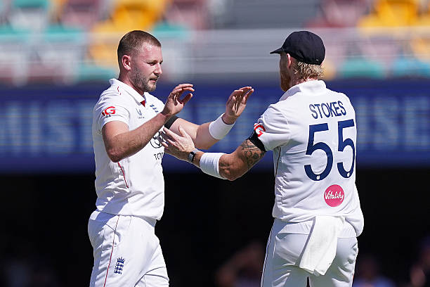 England's Gus Atkinson celebrates with teammate Ben Stokes after taking the wicket of Australia's Alex Carey on day three of the second NRMA...