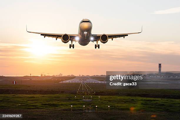 passenger airplane taking off at sunset - plane taking off stock pictures, royalty-free photos & images