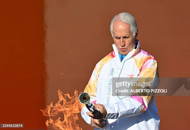President of the Milano Cortina 2026 Organizing Committee Giovanni Malago lights the torch at the Stadio dei Marmi one of four stadiums located in...