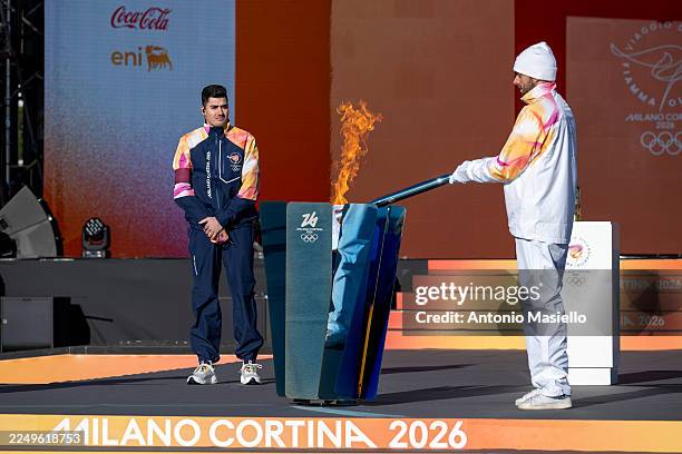 Italian swimmer Gregorio Paltrinieri lights the 2026 Milan Cortina Winter Olympics torch during the ceremony of the Olympic Torch Relay for the...