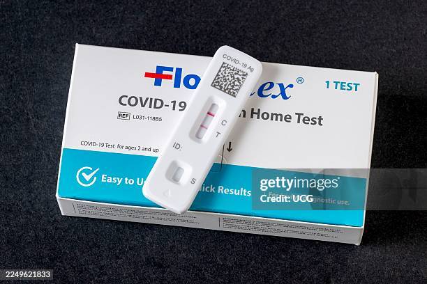 Positive Covid-19 home test on a black background.