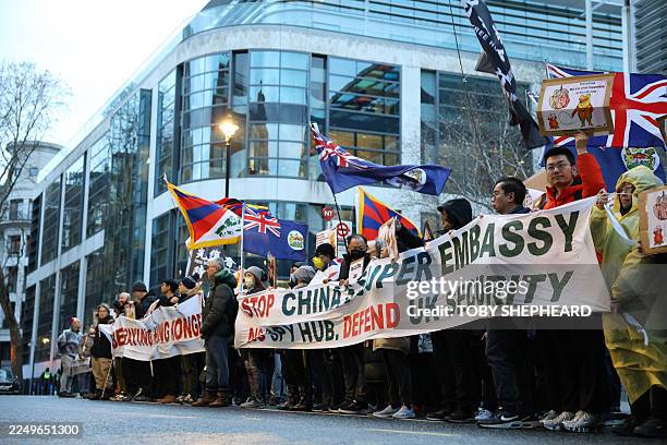 Protesters gather with placards in London on December 6 to demonstrate against a proposal to move China's embassy to a new site, a stones-throw from...