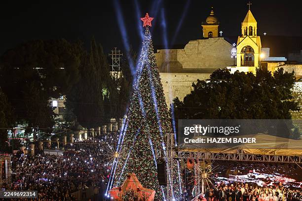 Spectators gather on Nativity Square during a Christmas tree lighting ceremony in Bethlehem, in the Israeli-occupied West Bank, on December 6, 2025.