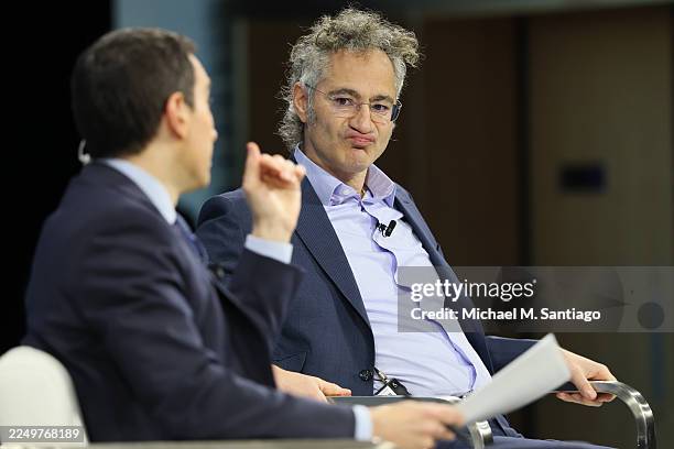 New York Times columnist Andrew Ross Sorkin and Palantir Co-founder and CEO Alex Karp speak onstage during the 2025 New York Times Dealbook Summit at...