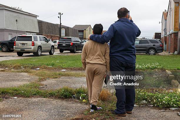 Community members watch Customs and Border Patrol Commander Gregory Bovino's caravan of federal agents during immigration enforcement operations in...