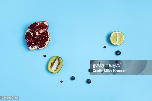 mixed fresh fruits on trendy light blue background - estilismo culinário imagens e fotografias de stock