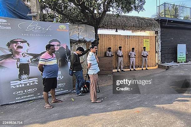 Police personnel stand guard outside a nightclub following a fire that broke out last midnight, in Goa on December 7, 2025. A fire at a nightclub in...