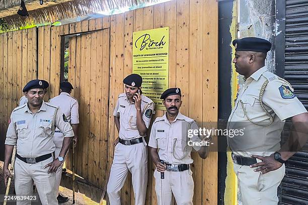 Police personnel stand guard outside a nightclub following a fire that broke out last midnight, in Goa on December 7, 2025. A fire that ripped...