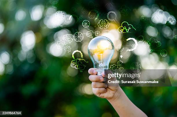 innovation. new concept ideas with innovations hand in hand with future lamp technology and inspiration in science and communication concepts. - new product development innovation stock pictures, royalty-free photos & images