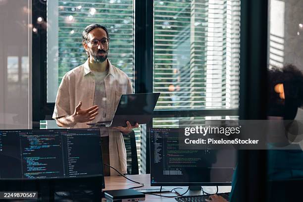 software engineers collaborating on a project, discussing on customer requirement concept, working flow diagram and analyzing code on computer monitors in office - api developer stock pictures, royalty-free photos & images