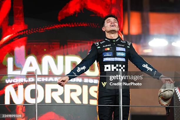 World Drivers Champion and Third placed Lando Norris of McLaren celebrates on the podium after Formula 1 Abu Dhabi Grand Prix at Yas Marina Circuit...