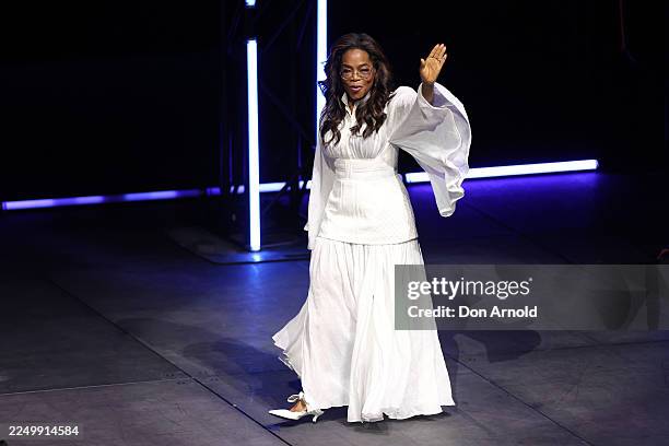 Oprah Winfrey greets the audience during the opening show of Oprah 'In Conversation' Australia 2025 tour at ICC Sydney Theatre on December 04, 2025...