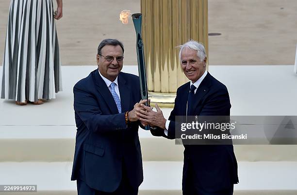 Isidoros Kouvelos, President of the Hellenic Olympic Committee, presents the Olympic Flame to Giovanni Malago, President of the Milano Cortina 2026...
