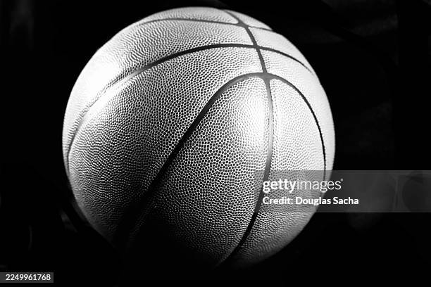 basketball on black background - college basketball stock pictures, royalty-free photos & images