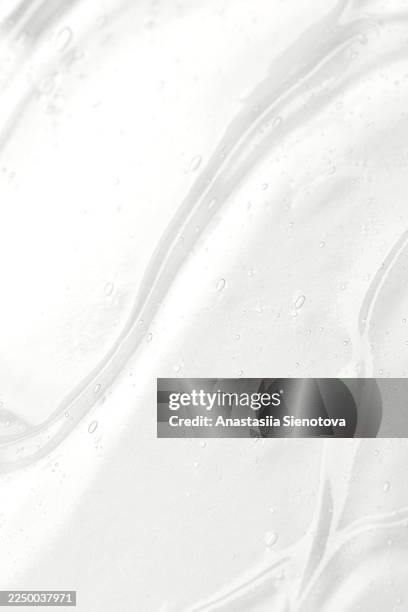 clear cosmetic gel creating abstract texture background. the color of the 2026 year - face serum stock pictures, royalty-free photos & images