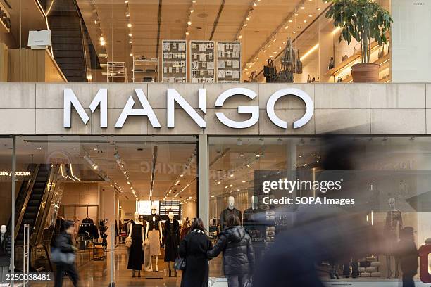 Brand and logo of a store front of Mango a Spanish owned fast-fashion outlet, busy with shoppers along Istiklal Street.