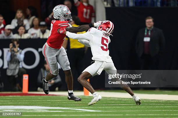 Ohio State Buckeyes wide receiver Jeremiah Smith stiff arms Indiana Hoosiers defensive back D'Angelo Ponds during the Big 10 Championship game...