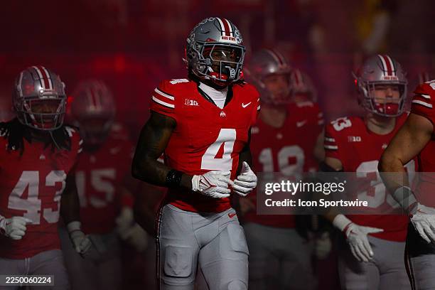 Ohio State Buckeyes wide receiver Jeremiah Smith runs out to the field during the Big 10 Championship game between the Ohio State Buckeyes and...
