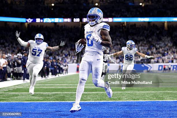 Jahmyr Gibbs of the Detroit Lions scores a touchdown against the Dallas Cowboys during the fourth quarter at Ford Field on December 04, 2025 in...