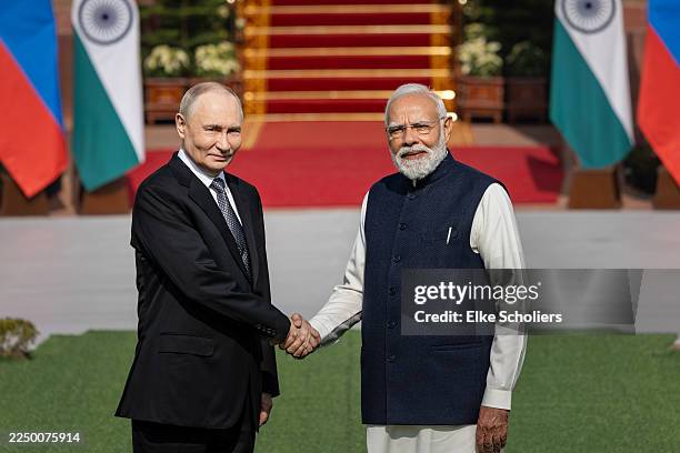 Russia's President Vladimir Putin and India's Prime Minister Narendra Modi shake hands ahead of their meeting at Hyderabad House on December 05, 2025...