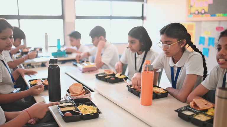 https://media.gettyimages.com/id/2250135678/video/students-enjoy-a-relaxed-lunch-break-together-eating-tiffin-boxes-and-sharing-conversation-at.jpg?b=1&s=640x640&k=20&c=khzsQJOkBopqcDoesnYwMaxEwqriMN7taNmz393gWDo=