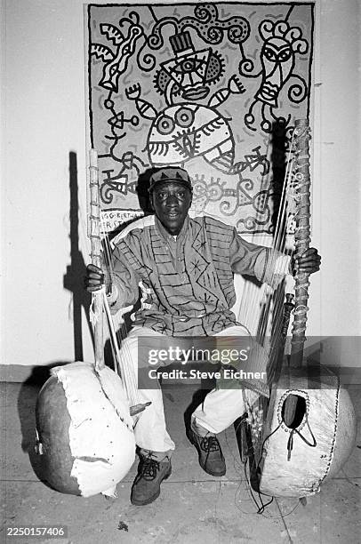 Portrait of Senegalese musician Vieux Diop , holding a pair of koras at Tramps, New York, New York, February 1995.