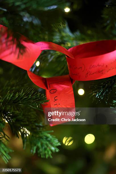 Paper chain garland signed by Prince Louis of Wales on a Christmas tree at the 'Together At Christmas' Carol Service at Westminster Abbey on December...