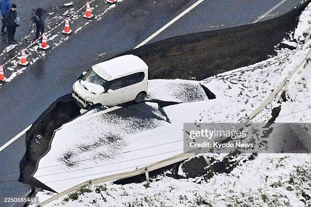 Photo taken from a Kyodo News airplane on Dec. 9 shows a collapsed road in Tohoku in Aomori Prefecture, northeastern Japan, following a strong...