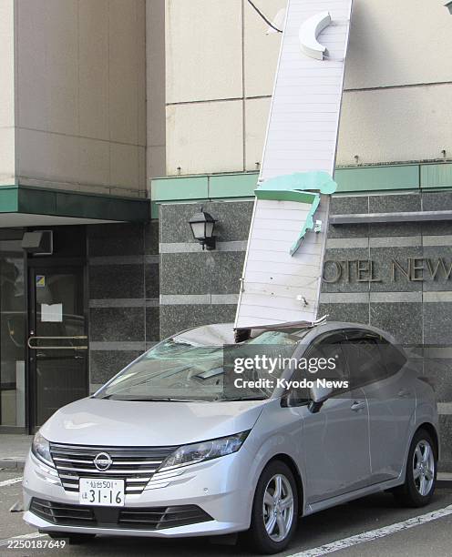 Photo shows a car damaged by a fallen signboard in Mutsu in Aomori Prefecture, northeastern Japan, on Dec. 9 following a strong earthquake the...