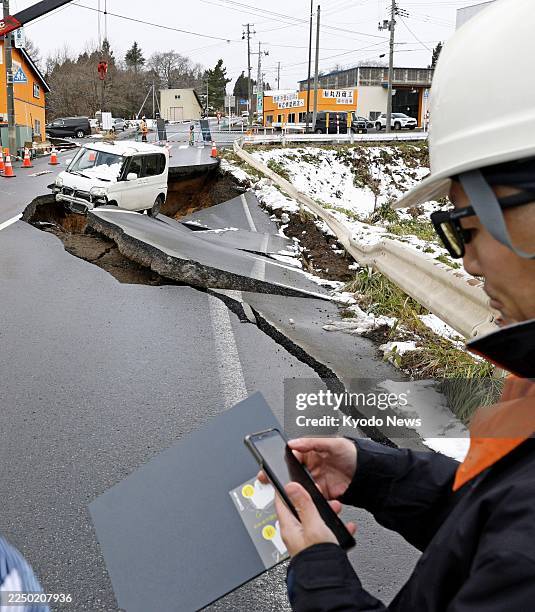 Collapsed road is pictured in Tohoku in Aomori Prefecture, northeastern Japan, on Dec. 9 following a strong earthquake the previous night.