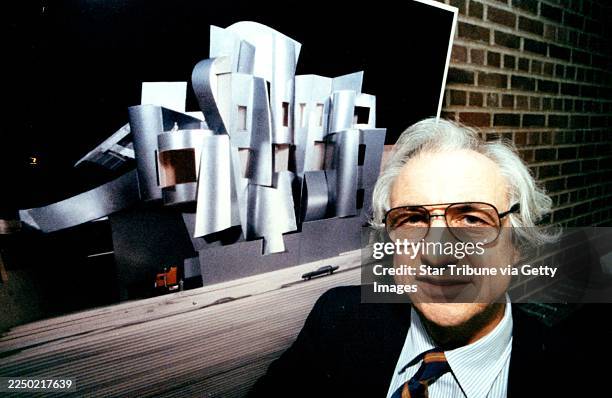 Architect Frank Gehry stands next to a photographic model of the new art museum building he designed for the University of Minnesota's Minneapolis...