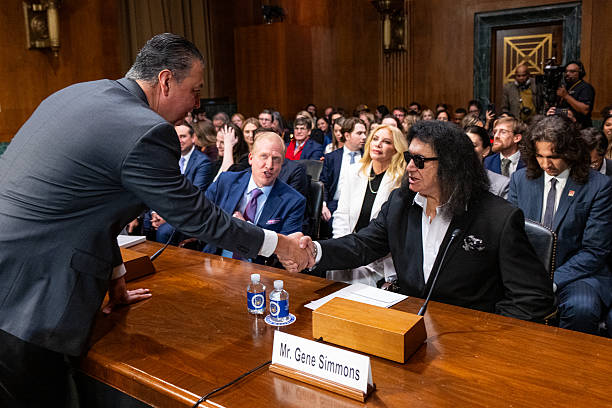 Sen. Alex Padilla, D-Calif., shakes hands with Gene Simmons during the Senate Judiciary Subcommittee on Intellectual Property hearing on "Balancing...