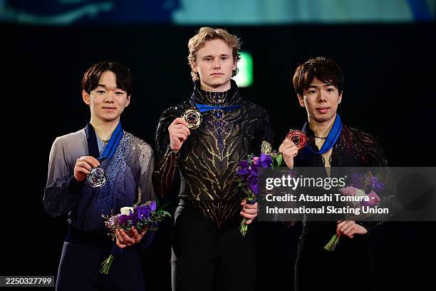 Gold medalist Ilya Malinin of the United States , silver medalist Yuma Kagiyama of Japan and bronze medalist Shun Sato of Japan pose on the podium at...