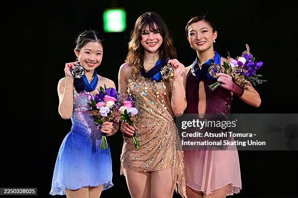 Gold medalist Alysa Liu of the United States , silver medalist Ami Nakai of Japan and bronze medalist Kaori Sakamoto of Japan pose on the podium at...