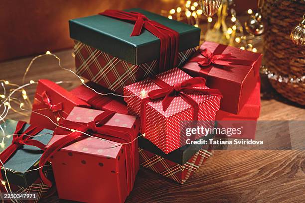assorted giftboxes near christmas tree in basket with glass baubles and crystal beads. close-up elevated view. christmas or new year celebration. season's greetings - crystal christmas tree ornaments fotografías e imágenes de stock