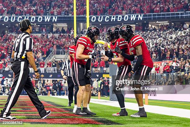 Coy Eakin of the Texas Tech Red Raiders celebrates with teammates after scoring a touchdown during the second half of the Big 12 Championship game...