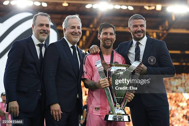 José Mas, Jorge Mas and Sir David Beckham, co-owners of Inter Miami CF pose with the Champion's trophy next to Lionel Messi after winning the Audi...