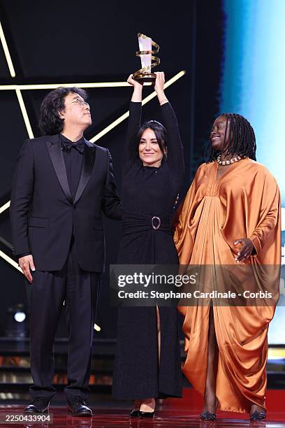 Bong Joon-ho, Aïssa Maïga and Erige Sehiri pose on stage after receiving the Étoile D'Or award for the film Promised Sky during the Closing Ceremony...