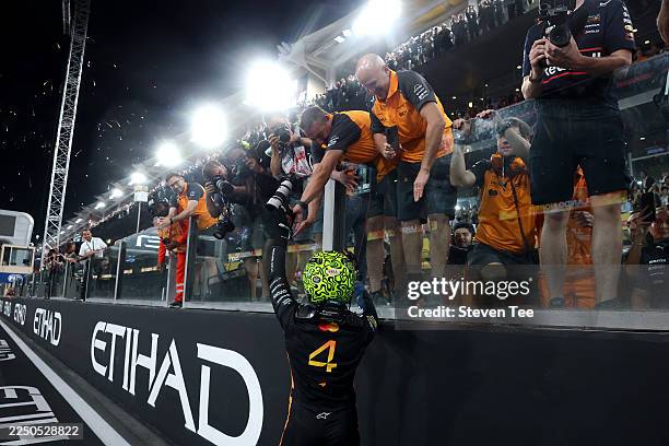 World Drivers Champion and Third placed Lando Norris of Great Britain and McLaren celebrates with his team in parc ferme during the F1 Grand Prix of...
