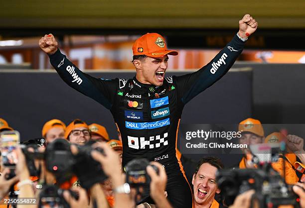 World Drivers Champion Lando Norris of Great Britain and McLaren celebrates with his team during the F1 Grand Prix of Abu Dhabi at Yas Marina Circuit...