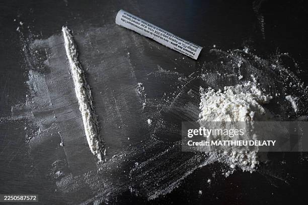 Line and a pile of fake cocaine made with flour next to a fake cocaine straw are placed on a table in Lyon in France on December 11 2025.