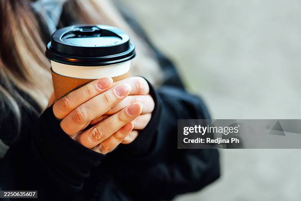 hands holding takeaway coffee cup outdoors - disposable cup stock pictures, royalty-free photos & images