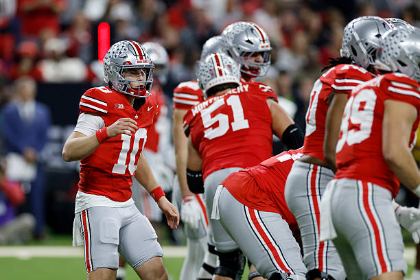 Julian Sayin of the Ohio State Buckeyes directs the offense before the snap during the Big Ten Championship Game against the Indiana Hoosiers on...