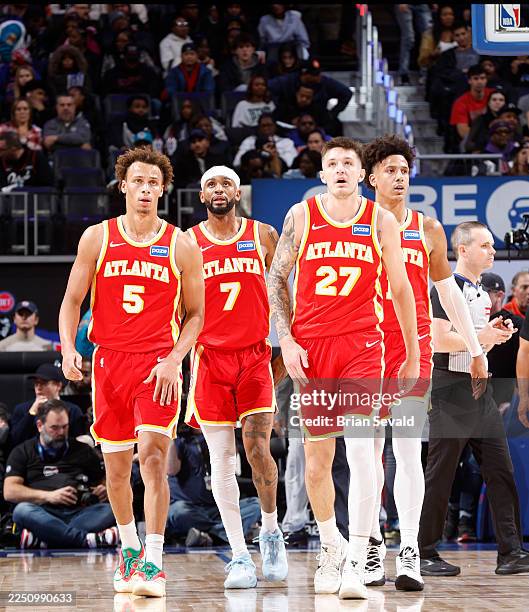 Dyson Daniels, Nickeil Alexander-Walker, Vit Krejci, and Jalen Johnson of the Atlanta Hawks looks on during the game against the Detroit Pistons on...