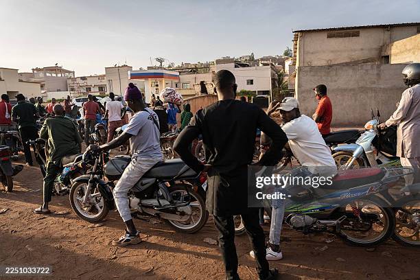 Motorcyclists line up to get fuel at one of the few petrol stations with supply in Bamako on December 10, 2025. Jihadists attacked a fuel tanker...