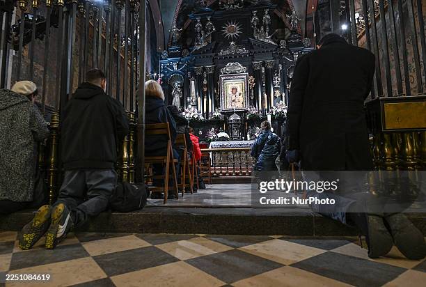 Pilgrims and worshippers pray inside the Chapel of Our Lady of Czestochowa, with the revered image of the Black Madonna at the center, at Jasna Gora...