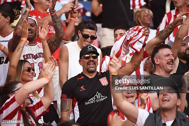 Estudiantes' Argentine president and former player Juan Sebastian Veron cheers for his team among fans ahead of the Argentine Professional Football...
