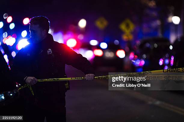 Police officers remain on the scene of a shooting that killed two and wounded at least eight at Brown University on December 13, 2025 in Providence,...