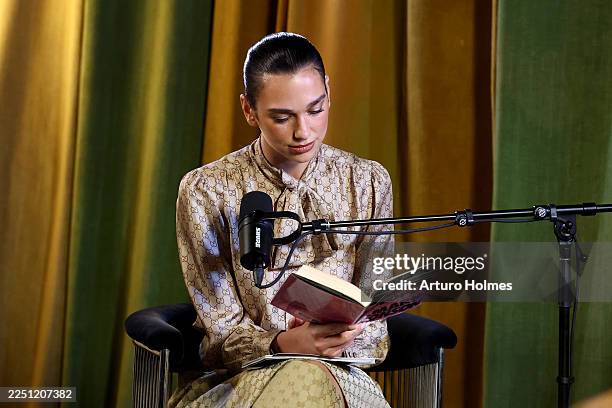 Dua Lipa speaks onstage during Dua Lipa's "Service95 Book Club" with Mark Ronson at The Chelsea Hotel on December 09, 2025 in New York City.